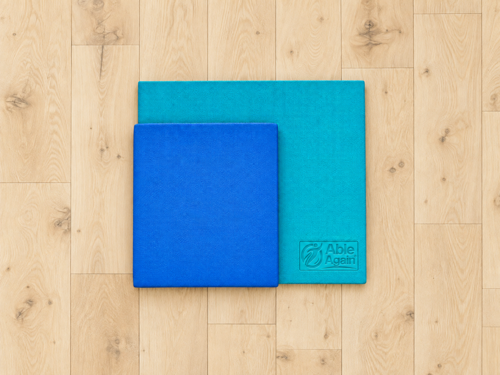 Smaller blue competing pad overlapping the larger teal Able Again balance pad