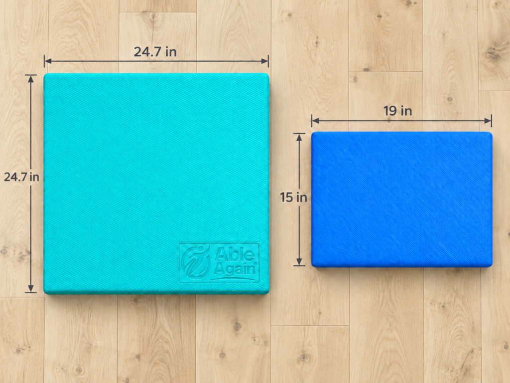 Able Again teal balance pad, 24.7 x 24.7 inches, next to a smaller blue competing pad, 19 x 15 inches